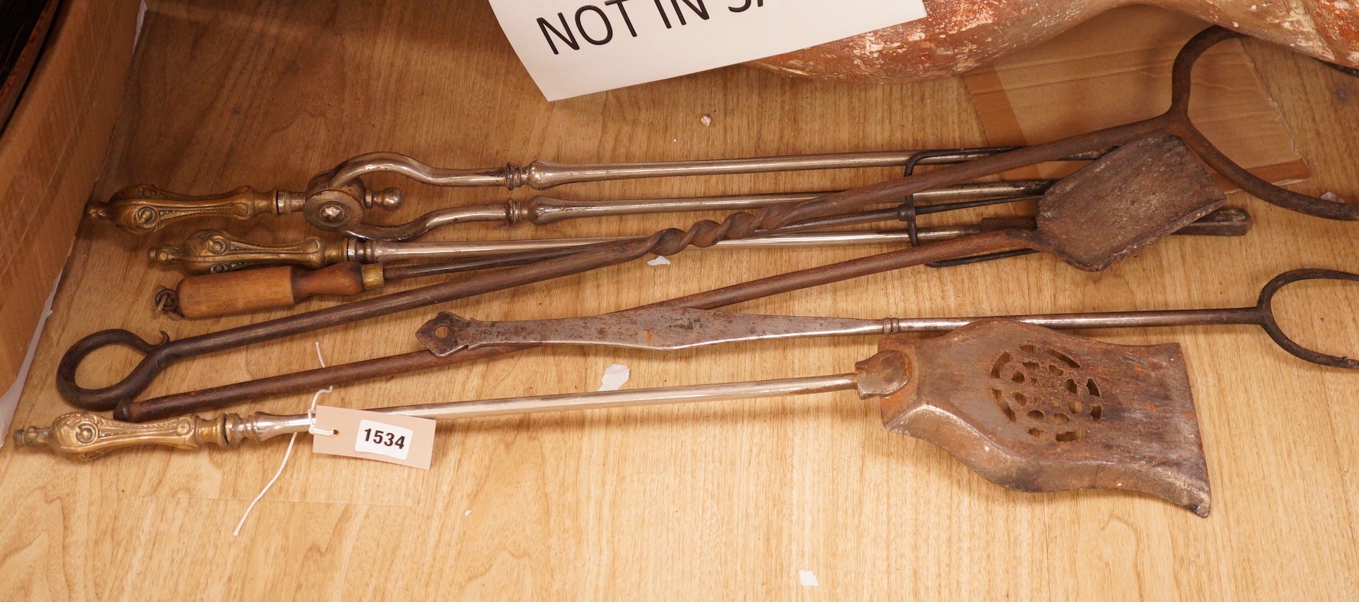 A set of three 19th century steel and brass fire irons and others